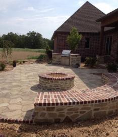 outdoor brick and stone firepit surrounded by retaining wall 