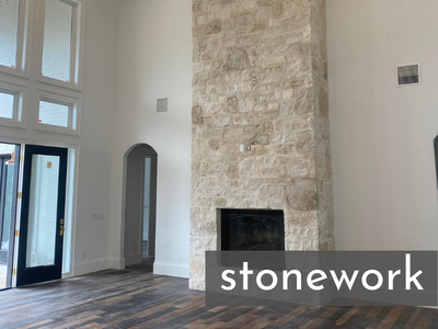 custom fireplace with floor to ceiling stone surround